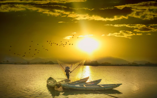 Sunset photography of a lone fisherman casting a net from a small boat, golden light over calm water — 4K Ultra HD PC desktop wallpaper and background.