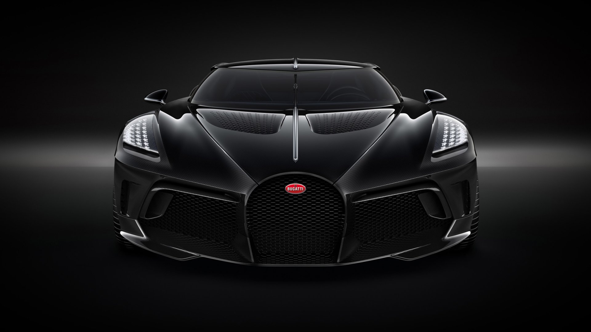 HD desktop wallpaper featuring a sleek black Bugatti La Voiture Noire sports car against a dark background, highlighting its elegant design and powerful stance.