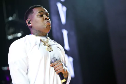 HD desktop wallpaper featuring a person on stage holding a microphone in a performance pose, suitable as a background.